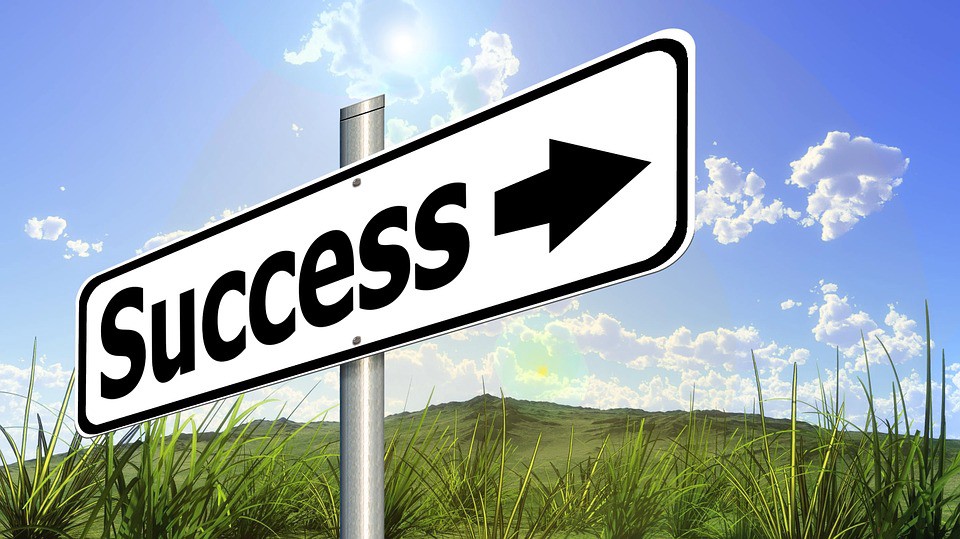 Street sign that says Success