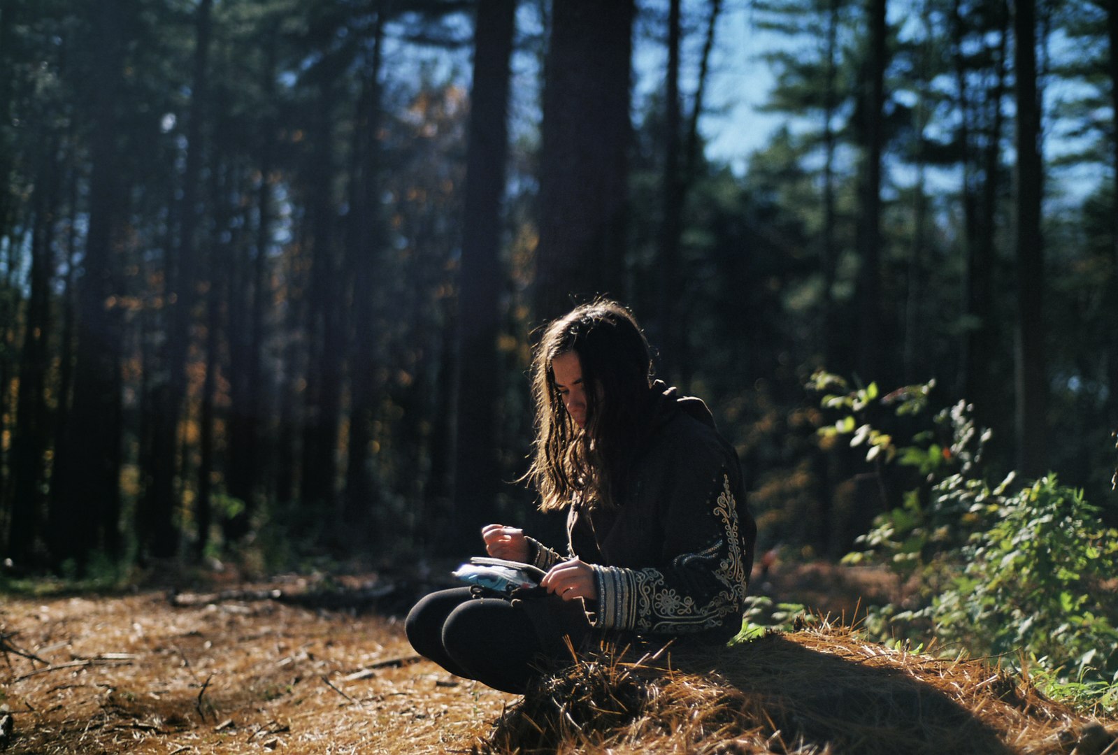 Young woman journaling in the forest