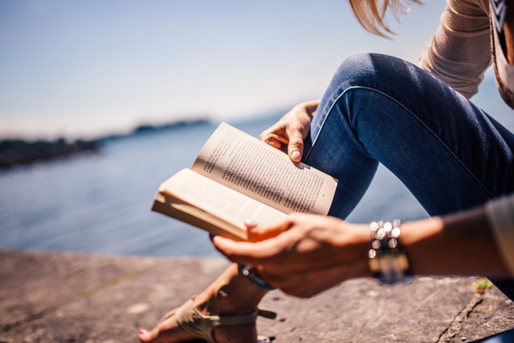 Woman sitting on a beach reading