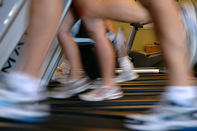 Blurry image of people running on treadmills